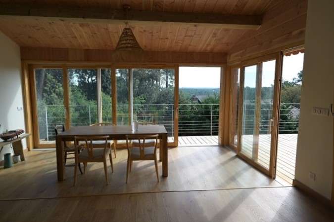 Baie coulissante en bois avec vue sur canopée